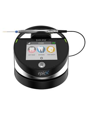 High-quality dental laser equipment in a clinical setting, with focus on the device and its controls on a white countertop